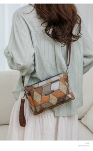 Detail of geometric patchwork cross-body bag with multi-color leather texture and metal logo