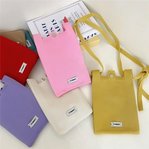 Minimalist knit crossbody phone bags in vibrant colors with metallic snap button closure