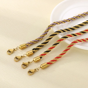 Detail of woven rope bracelets with 18K gold-plated links and lobster clasps