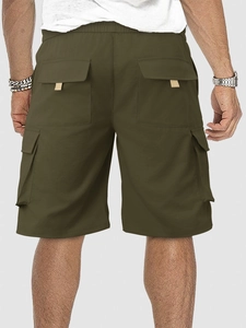 Detail of army green cargo shorts featuring elastic waistband and flap back pockets