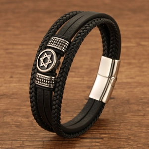 Detail of multi-layer black leather bracelet with silver Star of David charm and steel clasp