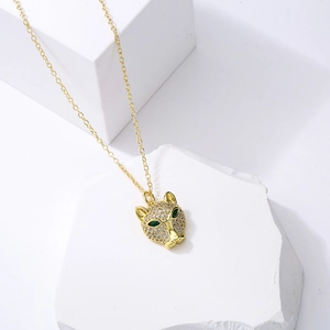 Gold plated leopard head necklace with clear zircons and green eyes on white stones