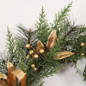 Handcrafted Christmas wreath with golden berries, pine needles, and a satin ribbon bow