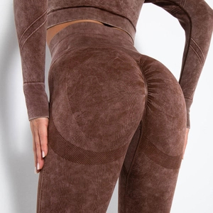 Detail of acid wash yoga pants showing ruched peach lift and breathable mesh textures