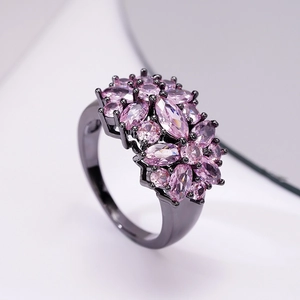 Macro shot of cocktail ring with pink marquise stones and black plating detail