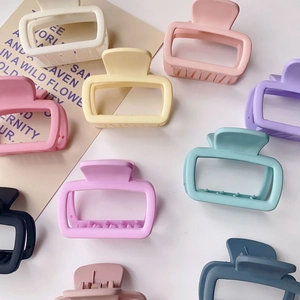 Top view of colorful square matte hair claws in various shades on a white background