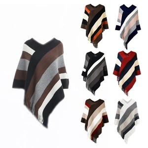 Detail view of multi-color striped knitted ponchos with elegant fringe and V-neckline