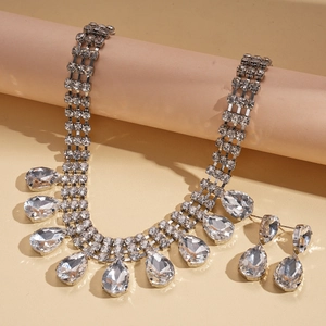 Vue détaillée du collier avec pompon en cristal et boucles d'oreilles goutte d'eau