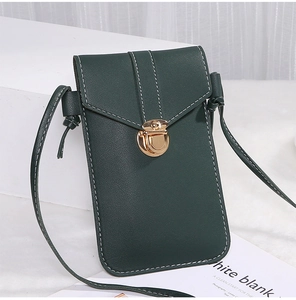 Close-up of dark green crossbody bag with lychee texture and golden metal buckle clasp