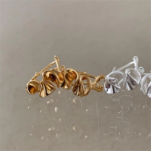 Minimalist wavy heart stud earrings in gold and silver finish with metallic gloss