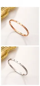 Detail of honeycomb geometric bangles in rose gold and silver finishes with crystal pavé