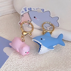 Cute shark-pig and blue shark animal keychains with gold clasps on display cards
