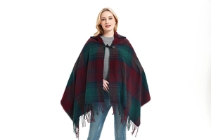 Detail of plaid acrylic hooded poncho with toggle button and fringe hem in wine red and green