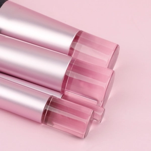 Detailed view of pink gradient makeup brush handles with transparent acrylic ends
