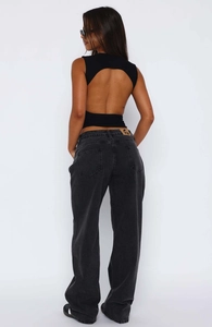 Rear view of backless black halter top paired with vintage dark gray wide leg jeans