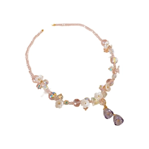 Colorful beaded flower necklace with purple crystal pendants and pink accents on white