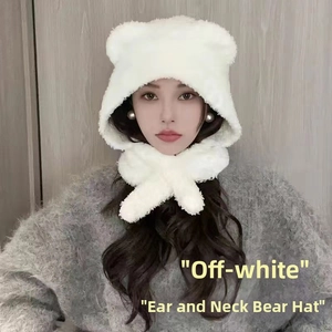 Detail view of off-white plush bear hat featuring integrated scarf and cute ears for winter