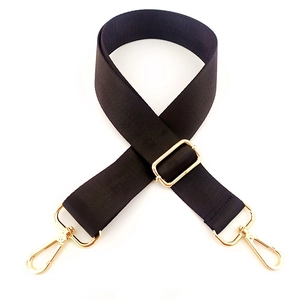 Adjustable black nylon bag strap with gold metal buckles and swivel hooks detail