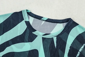 Close-up of crew neck stitching on a green and blue striped long sleeve t-shirt