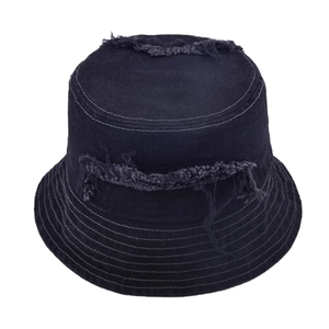Close-up of distressed edges and frayed denim texture on a flat top bucket hat