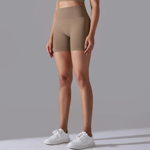 Detailed side view of high-waisted seamless taupe sports shorts for yoga and fitness