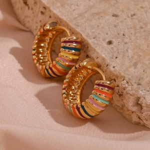 Detailed macro view of 18K gold plated hoop earrings with colorful enamel rainbow stripes