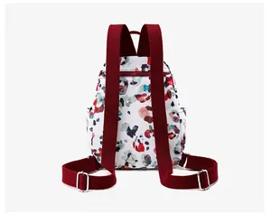 Detail view of printed canvas backpack back with wine red straps and hidden zipper pocket