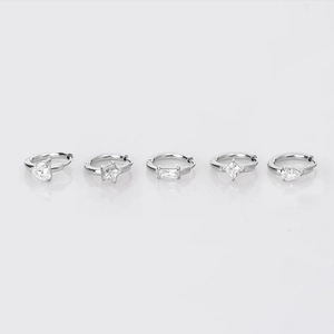 Detail of five pairs of silver hoop earrings featuring various cubic zirconia gemstone shapes