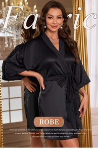 Detail of a black satin robe featuring tie waist tassels and elegant v-neckline