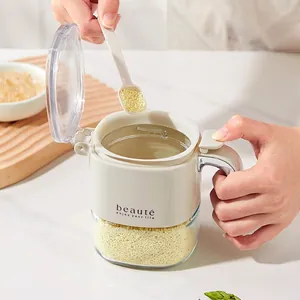 Creamy white glass seasoning jar with flip lid and spoon in a cozy kitchen setting