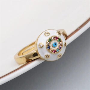 Detailed close-up of adjustable evil eye ring with colorful gemstone inlay on white enamel