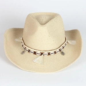 Detail of hand-woven straw cowboy hat featuring shell beads and ethnic tassel trim