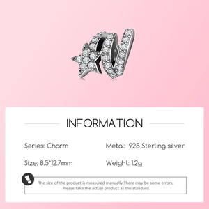 Macro detail of S925 sterling silver letter W charm with micro-pave star and zircon stones