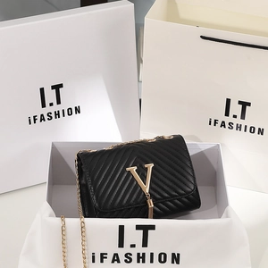Elegant black chevron quilted shoulder bag with gold V-logo, tassel and chain strap