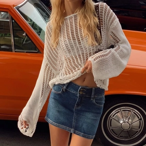 White crochet knit long sleeve cover up beach top paired with denim skirt