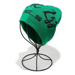 Detail of emerald green knitted beanie with black letter jacquard on a display stand