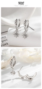 Detailed close-up of silver star pendant hoop earrings with small diamond accents