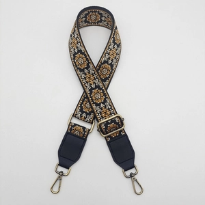 Detail of adjustable 38mm canvas bag strap with retro ethnic embroidery and bronze buckle