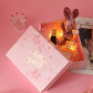 Detailed view of pink floral gift box featuring Love is Sweet gold foil lettering