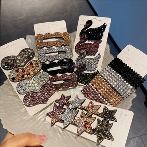 Sparkling rhinestone hair clips in geometric shapes like hearts and stars on display