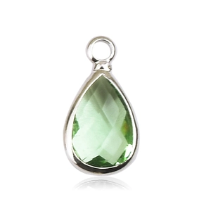 Detailed close-up of a green birthstone pendant with faceted glass and silver frame