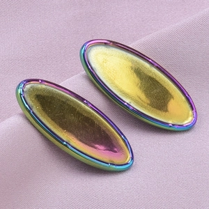 Macro detail of oval heart base earrings featuring vibrant colorful rainbow electroplating