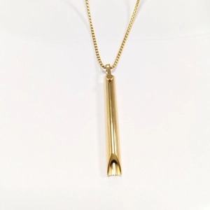 Detail of the golden cylinder meditation pendant showing the hollow breathing tube design