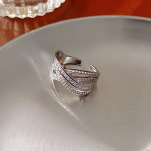 Macro shot of silver-tone multi-layer crisscross ring with pavé zircon stones