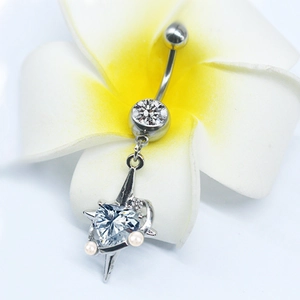 Close-up of silver belly button ring featuring heart-shaped zircon and small pearls