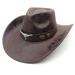 Detail of dark brown faux suede cowboy hat with silver bull skull and leather band decoration