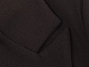 Macro shot of high-quality black twill fabric and layered stitching on the blazer suit