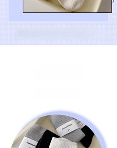 Detailed view of combed cotton socks with vertical rib texture and branded packaging