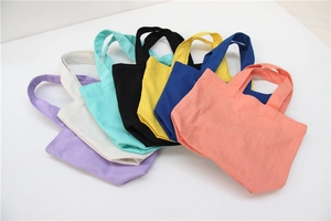 Selection of small canvas lunch bags in seven colors displayed in a fan-shaped arrangement