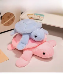 Close-up of soft plush sea turtle dolls showing fluffy pink and blue textured faux fur
